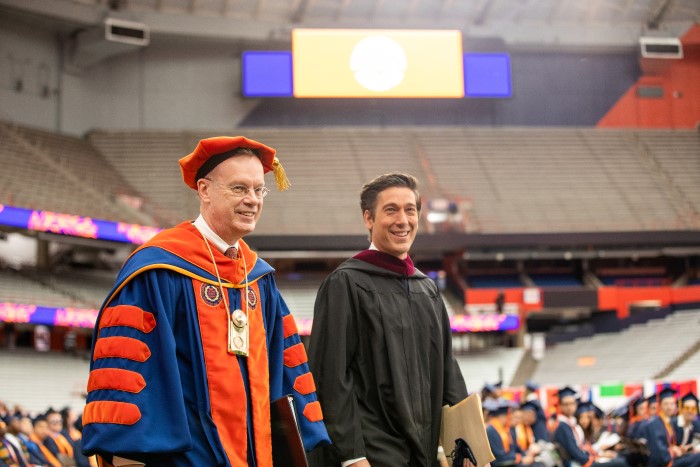 Chancellor Kent Syverud walks with Commencement Speaker, David Muir, as they process into the JMA Wireless Dome at the start of the 2022 Commencement ceremony