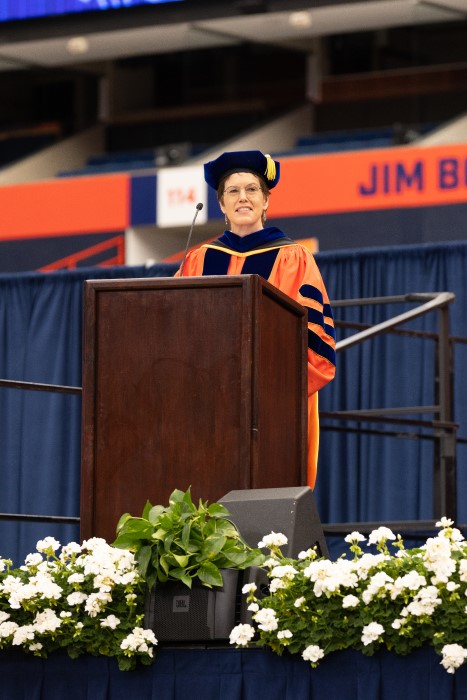 Provost Gretchen Ritter addresses the 2022 graduates from the podium during SU’s 2022 Commencement ceremony