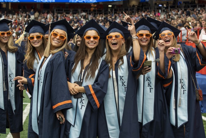Group of Kappa Kappa Gamma sorority sisters wearing orange sunglasses celebrate together